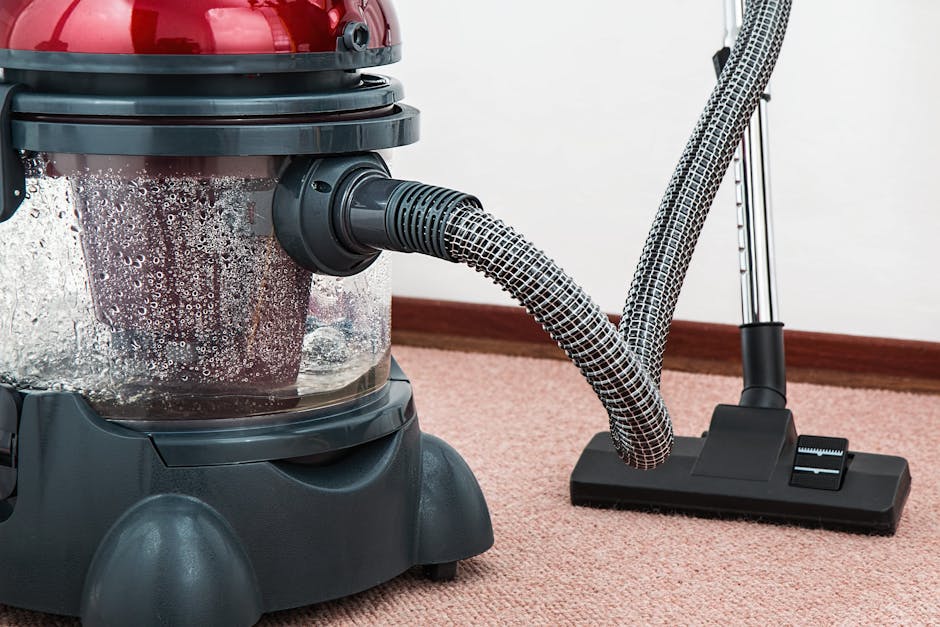 Close-up of a modern vacuum cleaner with water filtration on carpet floor indoors