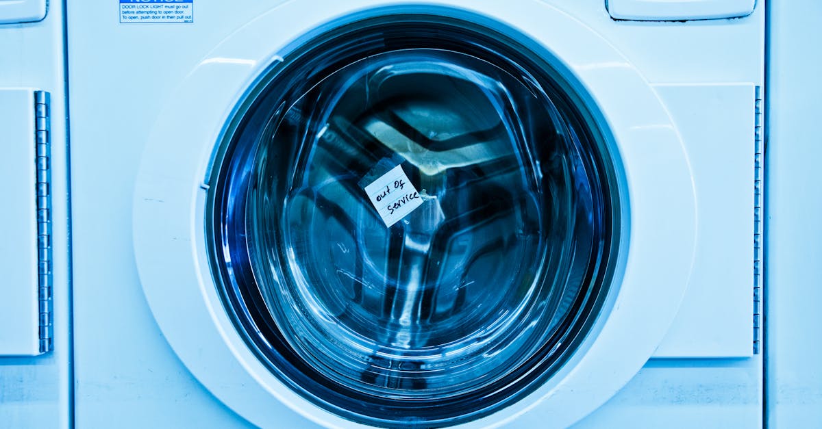 Close-up of an out-of-service washing machine in a laundromat with a blue tint