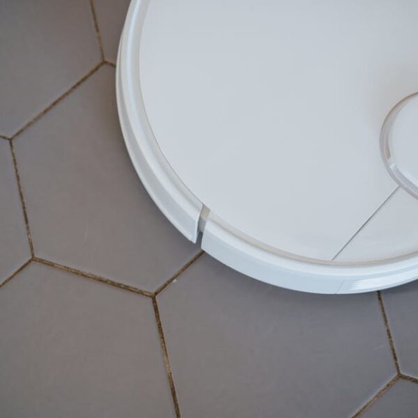 Close-up of a robotic vacuum cleaner on hexagonal tiles for efficient cleaning