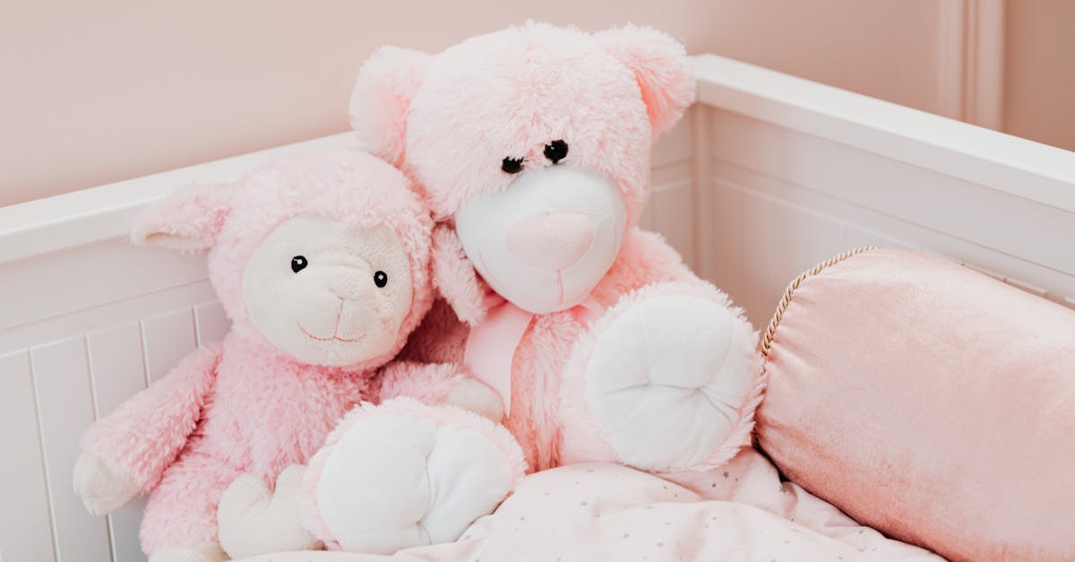 Cute pink plush toys on a bed in a childrens room, exuding comfort and innocence